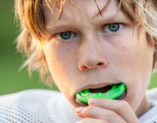 high school football player with custom fitted mouthguard